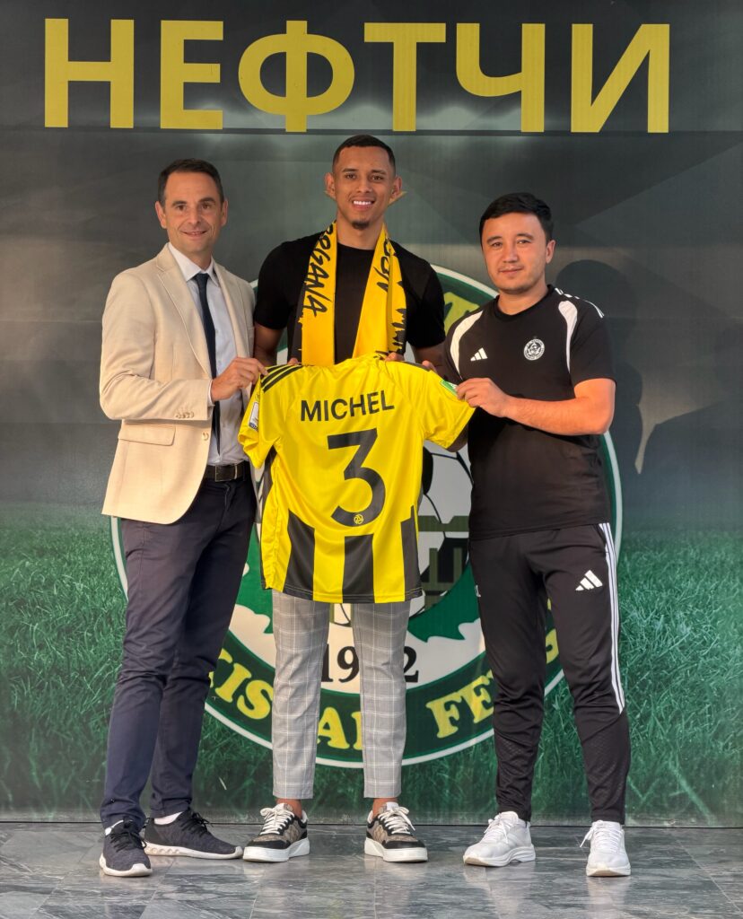 Michel Augusto is unveiled as a Neftchi Fergana player alongside his agent, former French footballer Grégoire Akcelrod (left), and Neftchi head coach Islom Ismoilov (right)